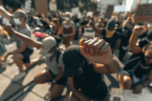 Protesters kneeling with fists raised
