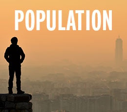person on cliff overlooking city with text population