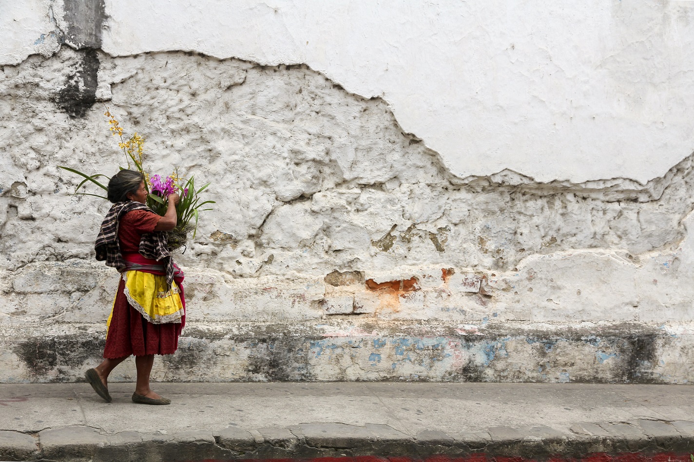 Woman walking near stucco. Photo by Scott Umstattd on Unsplash