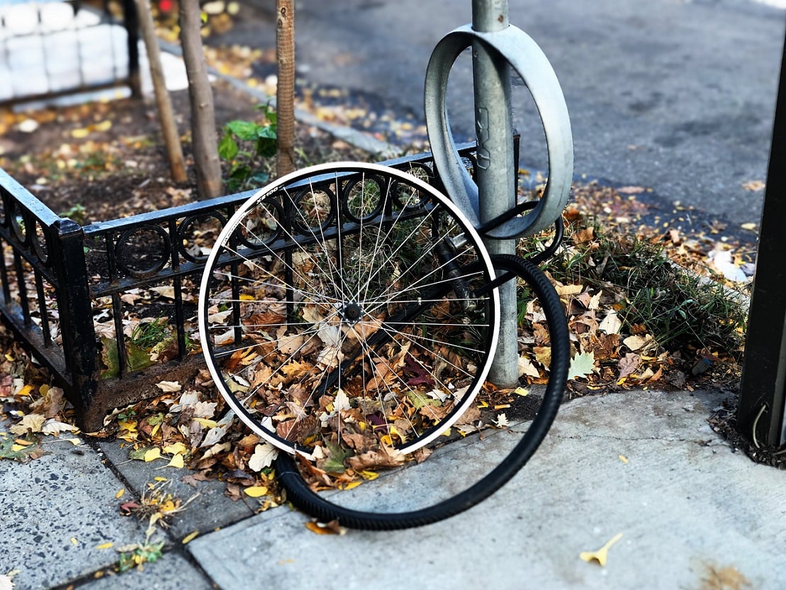 Bike wheel and tire. Photo by Lance Grandahl on Unsplash.