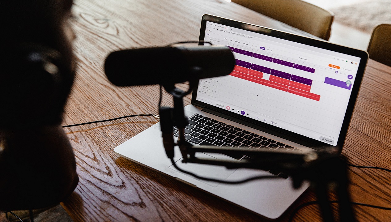 Laptop with large microphone. Photo by Soundtrap on Unsplash.
