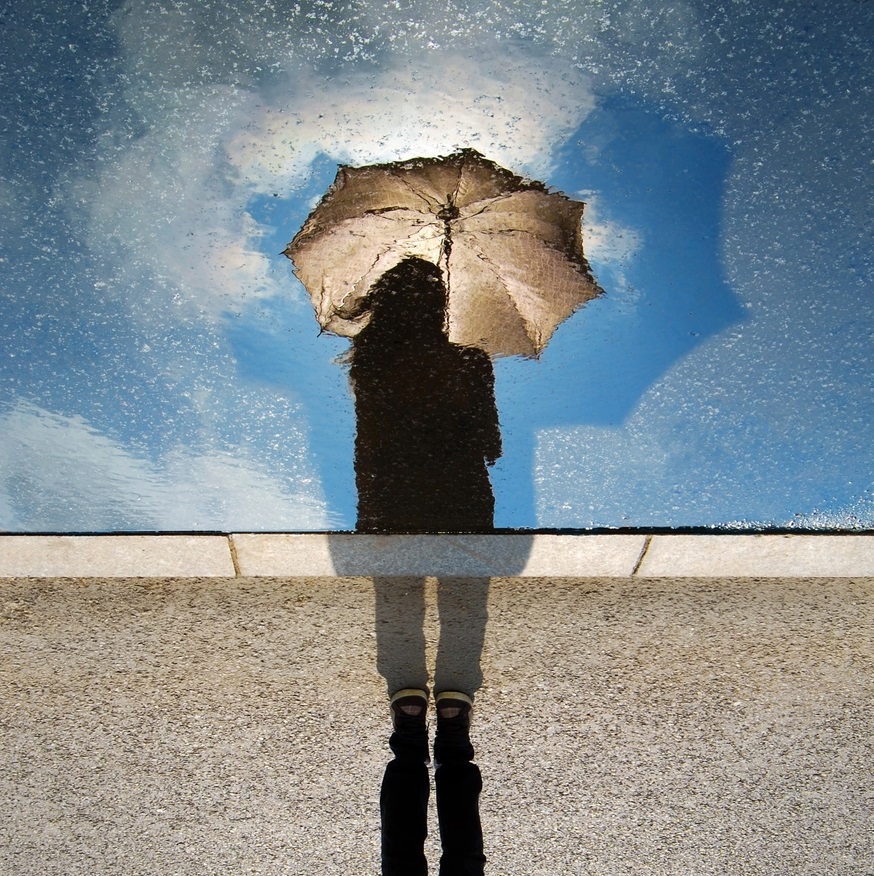 Silhouetted girl holding umbrella